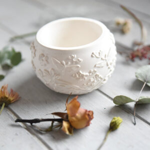 Tavaszi kaspó dekoráció: egy letisztult, fehér gipszből készült kisméretű virágtartó. Ez a tavaszi hangulatú asztali dísz tökéletes választás kisebb szobanövényekhez, szukkulensekhez vagy dekorációs célra.